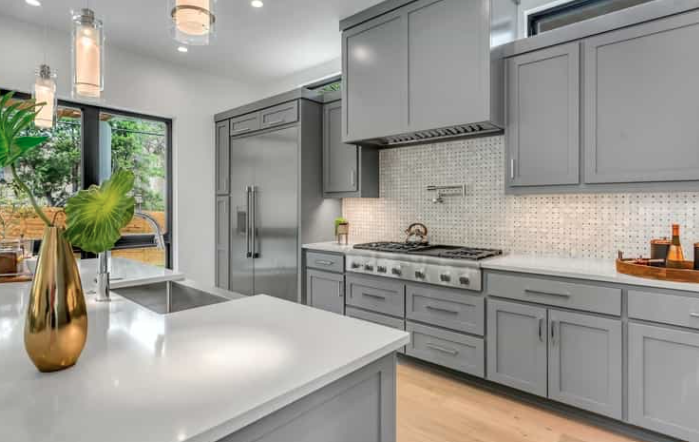 Gray kitchen cabinets have seen a big lift in popularity recently, and it appears that this movement may continue to boom in kitchen remodels. Gray cabinets offer significant neutrality and versatility, similar to old staples like white kitchen cabinets. Its adaptability is a major advantage, the ability to work with almost any kitchen design or color combination. Whether you prefer raised panels, Shaker cabinets or even slab, gray will meet your renovation goals. Mixing different hues of the color is one approach, while other homeowners decide to use variants to the soothing grays with a vibrant citrus color – the choice is yours! Gray is the Most Flexible Color for Kitchen Cabinets The flexibility provided by the color grey is key for kitchen makeovers. Gray kitchen cabinets are ultra-modern and welcoming. Your personal style and how you choose to include these cabinets into your overall plan are key to a kitchen renovation. All kitchen layouts that you have in mind will most likely work into your design. Gray supplies the versatility you need, whether you go with a modest and crisp Shaker cabinet or a beautifully decorative product. An essential aspect of gray is that the slate allows you to get creative with all the shades. White and natural wood can be flexible as well, but don’t have all the subtle hues that gray does. You can change the entire mood of your kitchen based on the tone you choose. With such a blank canvas, you can use gray to go confidently where you may not have tried to plan before. Lighter gray tones will give a comfortable and snug feel to the space, while darker shades can provide striking contrasts but also a sense of relaxation. You can even use many hues of gray, with lighter and darker shades, to make your kitchen stand out and show off your creativity. The chances are unlimited. Neutral Grays Give Lots of Options One impressive edge of gray kitchen cabinets when contrasting other kitchen cabinet colors is the color’s neutrality as a backdrop to any kitchen. Any appliances you already own in your kitchen, white, black or chrome, will work well with this color. You can incorporate many materials, such as wood, brick, marble or more.Any type of flooring will mesh well with this cabinet tone. Moreover, gray kitchen cabinets will pair well with most countertops (even granit) to create the best kitchen you can dream up! With the base that the gray color provides, you can try a myriad of types of accents, color combinations and creative designs. Imagine it and visualize what you want in your remodel; this color will help your dream become a reality. Using gray kitchen cabinets as the core of your renovation project can tie together any style or design. Whether you want to create a more traditional kitchen, a modern industrial kitchen, or something in between, you can make it happen remarkably well with gray. You can develop a beach cottage kitchen with lighter, calming shades of gray, a silky and sophisticated metropolitan feel with darker tones, or you can play around with various stains and finishes to make a special look all your own. Remodelers are beginning to see another significant benefit of gray cabinets. For decades, white has been a prominent color for kitchen cabinets, but there is a continuing issue that gray cabinetry does not share. It becomes very evident quickly when white cabinets become discolored or grimy, but gray cabinets are much better at hiding these common stains. If you have kids running around the kitchen opening and closing cabinet doors and drawers with their sticky dirty hands, these flaws will pile up quickly. Gray cabinets can help be the answer you seek to help your kitchen stay fresh and clean. Gray Cabinets for Your Kitchen Surpass the Rest People are seeing the many advantages and appeals of gray cabinets today. They are quickly becoming as popular (or more popular) than white cabinets. Choosing gray kitchen cabinets allows you to meet any kitchen renovation or remodeling ambition that you think up. Look for quality kitchen cabinet retailers online to find the perfect gray cabinets you need. They might be the best fit you can find for your kitchen upgrade!