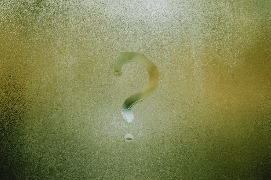 an image of a foggy window with a question mark on it